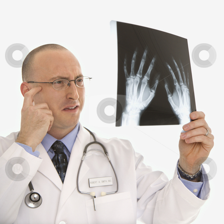 To use this stock image in your creative project, please select the size you need over to the right and click the "Add to Cart" button.
Your downloaded image will come with the Cutcaster watermark removed so don’t worry about the watermark you see on this page. Doctor looking at xrays. stock photo, Caucasian mid adult male physician holding up hand xrays looking perplexed. by Iofoto Images