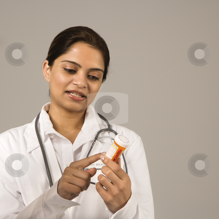Doctor explaining medication. Doctor explaining medication. stock photo, Indian woman doctor explaining medication. by Iofoto Images