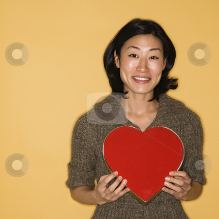 To use this stock image in your creative project, please select the size you need over to the right and click the "Add to Cart" button.
Your downloaded image will come with the Cutcaster watermark removed so don’t worry about the watermark you see on this page. Woman holding heart box. stock photo, Pretty mid adult Asian woman holding red heart shaped box. by Iofoto Images