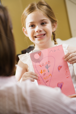 To use this stock image in your creative project, please select the size you need over to the right and click the "Add to Cart" button.
Your downloaded image will come with the Cutcaster watermark removed so don’t worry about the watermark you see on this page. Girl giving mom drawing. stock photo, Caucasian girl giving mid adult mother a drawing. by Iofoto Images
