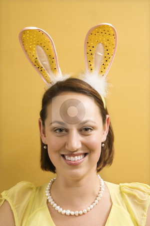 To use this stock image in your creative project, please select the size you need over to the right and click the "Add to Cart" button.
Your downloaded image will come with the Cutcaster watermark removed so don’t worry about the watermark you see on this page. Woman wearing rabbit ears. stock photo, Caucasian mid adult woman wearing rabbit ears and looking at viewer. by Iofoto Images
