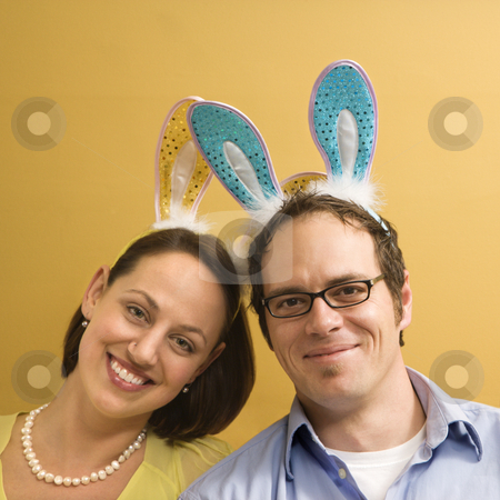 To use this stock image in your creative project, please select the size you need over to the right and click the "Add to Cart" button.
Your downloaded image will come with the Cutcaster watermark removed so don’t worry about the watermark you see on this page. Couple wearing rabbit ears. stock photo, Caucasian mid adult couple wearing rabbit ears and looking at viewer. by Iofoto Images