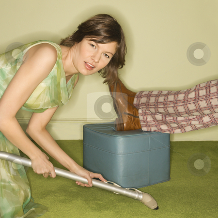 To use this stock image in your creative project, please select the size you need over to the right and click the "Add to Cart" button.
Your downloaded image will come with the Cutcaster watermark removed so don’t worry about the watermark you see on this page. Woman vacuuming carpet. stock photo, Unhappy pretty Caucasian mid-adult woman kneeling and vaccuuming carpet around male feet resting on foot stool. by Iofoto Images