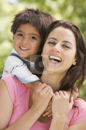 Woman and young boy embracing outdoors smiling Woman and young boy embracing outdoors smiling stock photo, by Monkey Business Images
