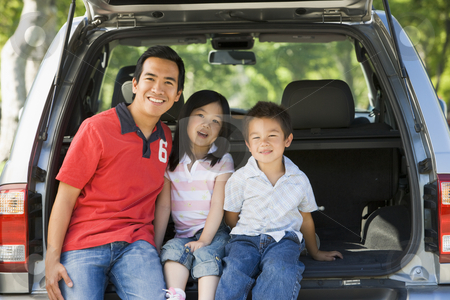 Man with two children sitting in back of van smiling Man with two children sitting in back of van smiling stock photo, by Monkey Business Images