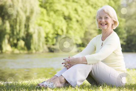 To use this stock image in your creative project, please select the size you need over to the right and click the "Add to Cart" button.
Your downloaded image will come with the Cutcaster watermark removed so don’t worry about the watermark you see on this page. Woman outdoors at park by lake smiling stock photo, by Monkey Business Images