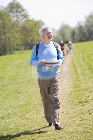 To use this stock image in your creative project, please select the size you need over to the right and click the "Add to Cart" button.
Your downloaded image will come with the Cutcaster watermark removed so don’t worry about the watermark you see on this page. Man walking outdoors holding map smiling with people in backgrou stock photo, by Monkey Business Images