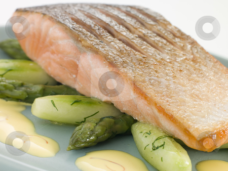 To use this stock image in your creative project, please select the size you need over to the right and click the "Add to Cart" button.
Your downloaded image will come with the Cutcaster watermark removed so don’t worry about the watermark you see on this page. Crisp Fried Salmon Supreme with Cucumber Asparagus and Hollandai stock photo, by Monkey Business Images