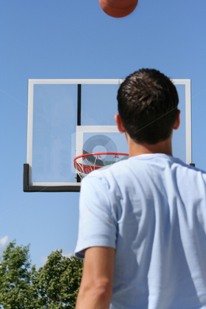 To use this stock image in your creative project, please select the size you need over to the right and click the "Add to Cart" button.
Your downloaded image will come with the Cutcaster watermark removed so don’t worry about the watermark you see on this page. Boy with Hoop - Horizontal stock photo, The rear view of a young boy facing a hoop as a basketball ascends toward it. Horizontally framed shot. by Orange Line Media