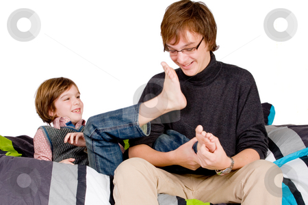 To use this stock image in your creative project, please select the size you need over to the right and click the "Add to Cart" button.
Your downloaded image will come with the Cutcaster watermark removed so don’t worry about the watermark you see on this page. Older brother is tickling the young one stock photo, Young happy child is getting tickled by his family by Frenk and Danielle Kaufmann