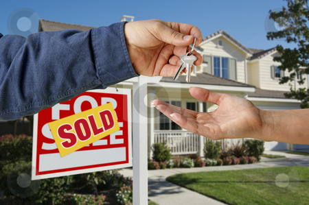 Handing Over the Keys to A New Home Handing Over the Keys to A New Home stock photo, Handing Over the Keys to A New Home with Sold Home For Sale Sign. by Andy Dean