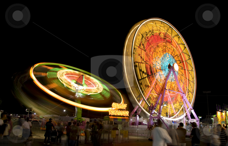 To use this stock image in your creative project, please select the size you need over to the right and click the "Add to Cart" button.
Your downloaded image will come with the Cutcaster watermark removed so don’t worry about the watermark you see on this page. Fair rides at night stock photo, Fair rides from a state fair viewed at night with a long shutter speed. by Robert Ranson