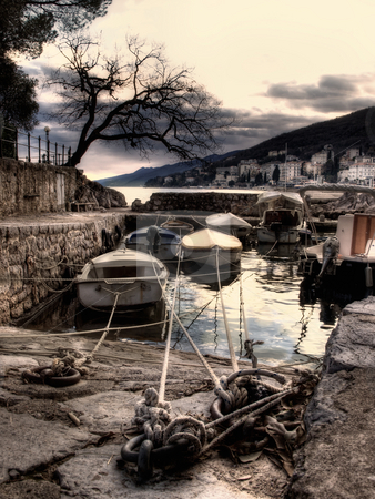To use this stock image in your creative project, please select the size you need over to the right and click the "Add to Cart" button.
Your downloaded image will come with the Cutcaster watermark removed so don’t worry about the watermark you see on this page. Winter in Opatija stock photo, Artistic view on boat in small harbor, in Opatija,Croatia by Sinisa Botas