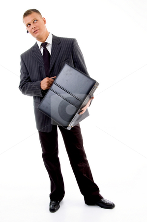 To use this stock image in your creative project, please select the size you need over to the right and click the "Add to Cart" button.
Your downloaded image will come with the Cutcaster watermark removed so don’t worry about the watermark you see on this page. Full pose of young executive holding leather bag stock photo, Full pose of young executive holding leather bag against white background by Imagery Majestic