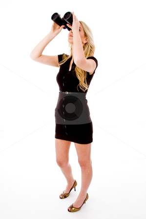 Side view of young woman looking through binocular Side view of young woman looking through binocular stock photo, Side view of young woman looking through binocular on an isolated white background by Imagery Majestic