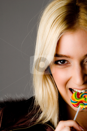 Close view of smiling woman eating candy Close view of smiling woman eating candy stock photo, Close view of smiling woman eating candy on an isolated white background by Imagery Majestic