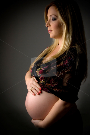 Side view of pregnant female showing her tummy Side view of pregnant female showing her tummy stock photo, Side view of pregnant female showing her tummy on an isolated white background by Imagery Majestic