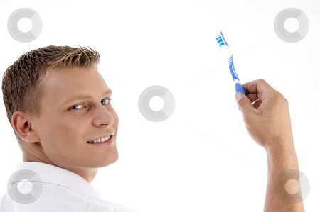 Adult caucasian holding toothbrush and posing to camera Adult caucasian holding toothbrush and posing to camera stock photo, Adult caucasian holding toothbrush and posing to camera with white background by Imagery Majestic