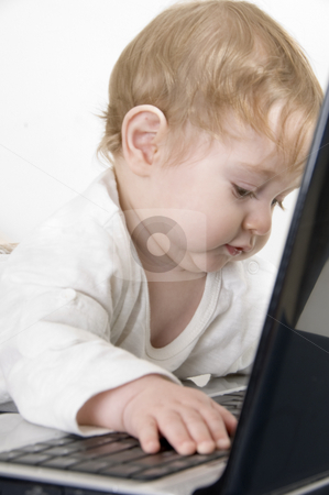 To use this stock image in your creative project, please select the size you need over to the right and click the "Add to Cart" button.
Your downloaded image will come with the Cutcaster watermark removed so don’t worry about the watermark you see on this page. Curious baby playing with laptop stock photo, Curious baby playing with laptop by Imagery Majestic