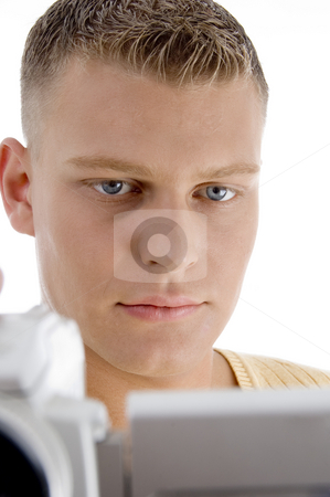 Young man looking videos Young man looking videos stock photo, Young man looking videos on an isolated white background by Imagery Majestic