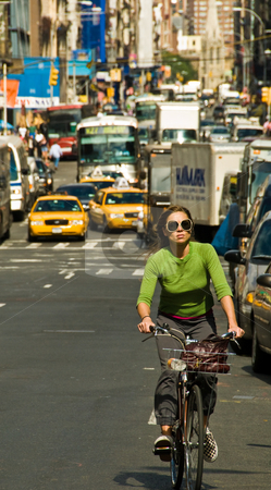 To use this stock image in your creative project, please select the size you need over to the right and click the "Add to Cart" button.
Your downloaded image will come with the Cutcaster watermark removed so don’t worry about the watermark you see on this page. New York City traffic stock photo, Woman on bike with dense traffic behind. Mid-town NYC by Ron Greer