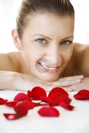 To use this stock image in your creative project, please select the size you need over to the right and click the "Add to Cart" button.
Your downloaded image will come with the Cutcaster watermark removed so don’t worry about the watermark you see on this page. Pampering stock photo, Smiling young femalebehind sprinkled rose-petals by Liv Friis-Larsen