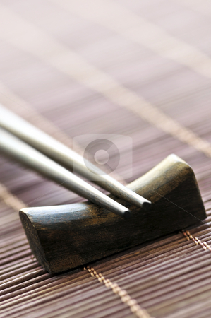 To use this stock image in your creative project, please select the size you need over to the right and click the "Add to Cart" button.
Your downloaded image will come with the Cutcaster watermark removed so don’t worry about the watermark you see on this page. Chopsticks stock photo, Set of wooden chopsticks on rest close up by Elena Elisseeva