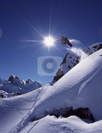 To use this stock image in your creative project, please select the size you need over to the right and click the "Add to Cart" button.
Your downloaded image will come with the Cutcaster watermark removed so don’t worry about the watermark you see on this page. Freeride snowboard stock photo, Snowboarder jumps high in dramatic mountain scene with white snow and clear blue sky. by Magnus Johansson