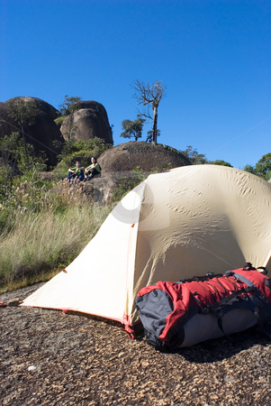 To use this stock image in your creative project, please select the size you need over to the right and click the "Add to Cart" button.
Your downloaded image will come with the Cutcaster watermark removed so don’t worry about the watermark you see on this page. Setup Camp stock photo, Vertically framed shot of a setup tent with the campers sitting on a rock bordered by deep blue sky in the distance. by Orange Line Media
