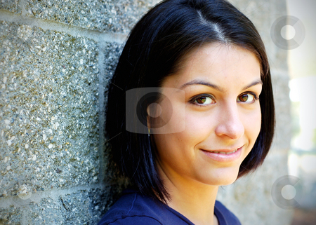 Cute Brunette Leaning on a Wall stock photo Closeup of an attractive young