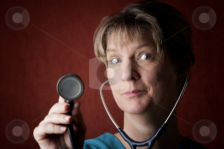 To use this stock image in your creative project, please select the size you need over to the right and click the "Add to Cart" button.
Your downloaded image will come with the Cutcaster watermark removed so don’t worry about the watermark you see on this page. Medical Professional stock photo, Female medical professional in scrubs with stethoscope by Scott Griessel