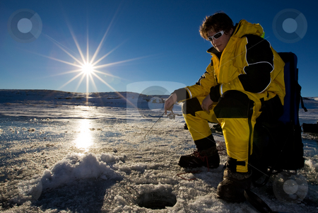 To use this stock image in your creative project, please select the size you need over to the right and click the "Add to Cart" button.
Your downloaded image will come with the Cutcaster watermark removed so don’t worry about the watermark you see on this page. Sunset fishing stock photo, Fisherman enjoying a day on the ice with a low setting sun by Steve Mcsweeny