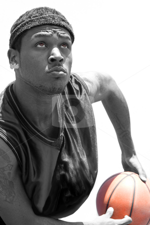 Basketball Player Basketball Player stock photo, A young basketball player gripping the ball tightly with selective color isolated over a white background.. by Todd Arena