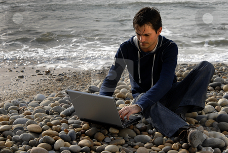 To use this stock image in your creative project, please select the size you need over to the right and click the "Add to Cart" button.
Your downloaded image will come with the Cutcaster watermark removed so don’t worry about the watermark you see on this page. Casual stock photo, Young casual man with laptop at the beach by Rui Vale de Sousa