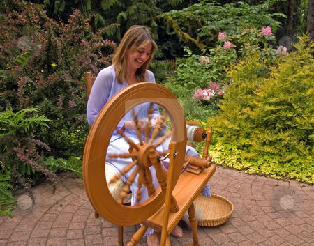 To use this stock image in your creative project, please select the size you need over to the right and click the "Add to Cart" button.
Your downloaded image will come with the Cutcaster watermark removed so don’t worry about the watermark you see on this page. Woman Enjoying Craftsmanship stock photo, This woman is enjoying creating her craft of spinning raw wool into yarn with a spinning wheel in a peaceful garden. by Valerie Garner