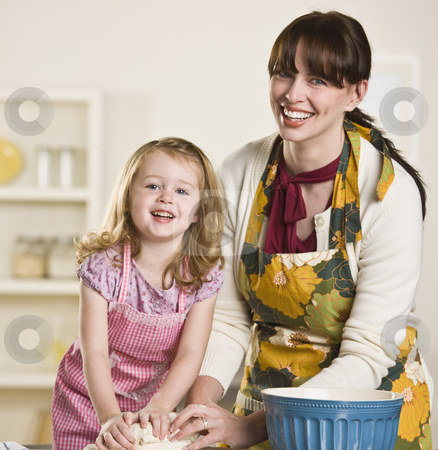 To use this stock image in your creative project, please select the size you need over to the right and click the "Add to Cart" button.
Your downloaded image will come with the Cutcaster watermark removed so don’t worry about the watermark you see on this page. Mom and daughter making bread stock photo, Brunette mom and blond daughter making bread on the kitchen counter, while wearing aprons. Both are kneading dough and looking at the camera. Square by Jonathan Ross
