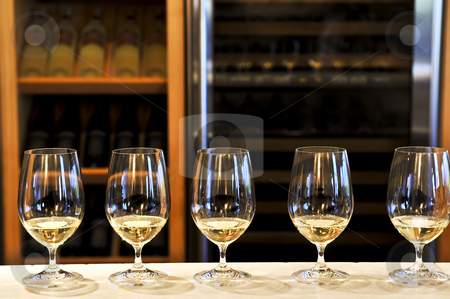 Wine tasting glasses Wine tasting glasses stock photo, Row of white wine glasses in winery tasting event by Elena Elisseeva