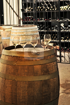 Wine glasses and barrels Wine glasses and barrels stock photo, Row of wine glasses on barrel in winery cellar by Elena Elisseeva