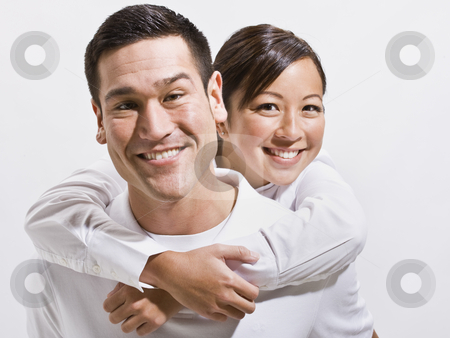 Attractive Young Couple Posing Attractive Young Couple Posing stock photo, An attractive young couple posing together. They are smiling directly at the camera. Horizontally framed shot. by Jonathan Ross