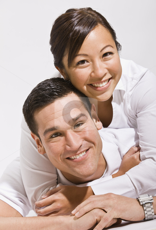 Asian couple hugging Asian couple hugging stock photo, Attractive asian couple hugging with woman on top.vertical by Jonathan Ross