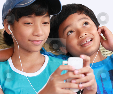 To use this stock image in your creative project, please select the size you need over to the right and click the "Add to Cart" button.
Your downloaded image will come with the Cutcaster watermark removed so don’t worry about the watermark you see on this page. Music gadget stock photo, 2 kids music sharing by Claro Alindogan