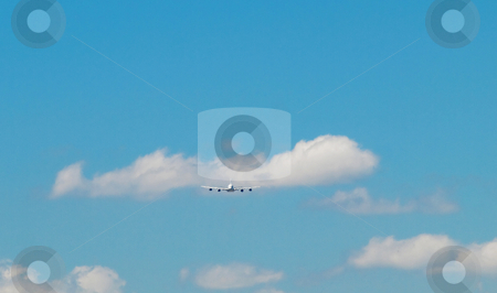 Jumbo airliner Jumbo airliner stock photo, Aircraft doing a landing approach under blue sky with clouds by Laurent Dambies