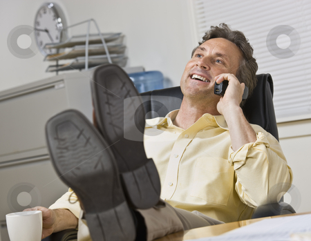 To use this stock image in your creative project, please select the size you need over to the right and click the "Add to Cart" button.
Your downloaded image will come with the Cutcaster watermark removed so don’t worry about the watermark you see on this page. Attractive business man on phone. stock photo, Attractive business man leaning back in chair, with legs on desk while chatting on the phone. Horizontal. by Jonathan Ross