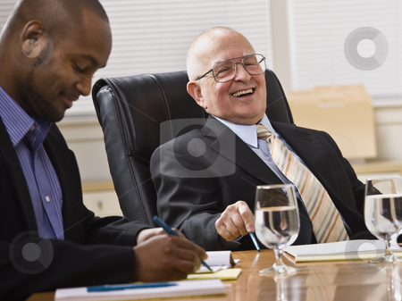 To use this stock image in your creative project, please select the size you need over to the right and click the "Add to Cart" button.
Your downloaded image will come with the Cutcaster watermark removed so don’t worry about the watermark you see on this page. Men in Business Meeting stock photo, An elderly man and a young businessman are seated together at a desk in an office. They are laughing and looking away from the camera. Horizontally framed shot. by Jonathan Ross