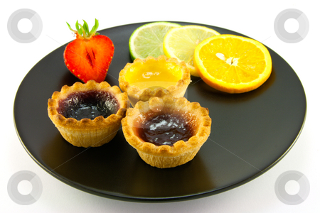 To use this stock image in your creative project, please select the size you need over to the right and click the "Add to Cart" button.
Your downloaded image will come with the Cutcaster watermark removed so don’t worry about the watermark you see on this page. Jam tarts on a Black Plate stock photo, Red and yellow small jam tarts with slices of lemon, lime, orange and strawberry on a black plate on a white background by Keith Wilson