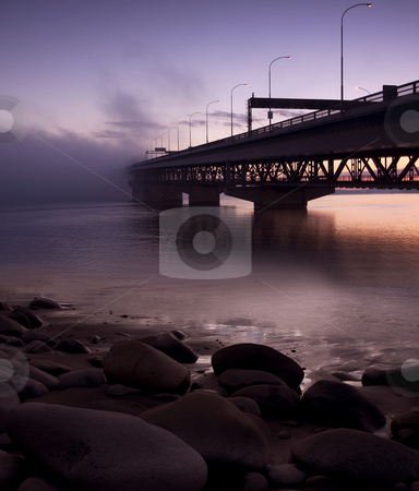 To use this stock image in your creative project, please select the size you need over to the right and click the "Add to Cart" button.
Your downloaded image will come with the Cutcaster watermark removed so don’t worry about the watermark you see on this page. Bridge to nowhere stock photo, Auckland Harbour bridge taken very early on a rare windless day by Robin Ducker