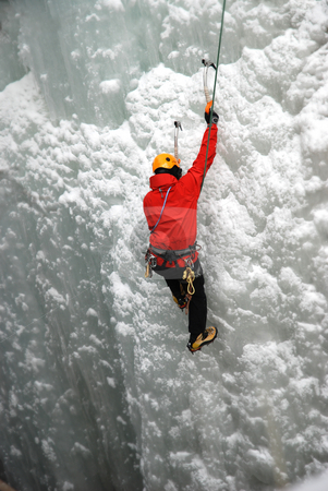 Ice Climber Ice Climber stock photo, An Ice Climber going up a frozen waterfall. by Damien Richard
