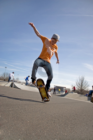 To use this stock image in your creative project, please select the size you need over to the right and click the "Add to Cart" button.
Your downloaded image will come with the Cutcaster watermark removed so don’t worry about the watermark you see on this page. Skateboarding Tricks stock photo, A young skateboarder doing a stunt in a skate park. by Todd Arena