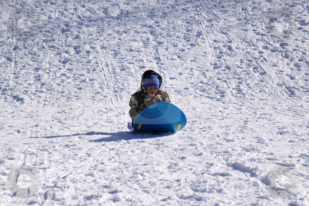 Little Boy Sledding down the Hill Little Boy Sledding down the Hill stock photo, Little Boy Sledding down the Hill - Winter Scenes by Mehmet Dilsiz