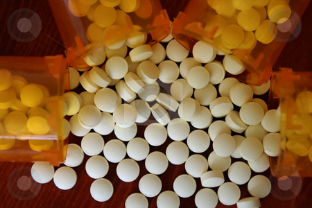 Bottles of Medicine Bottles of Medicine stock photo, Medicine spilling out of four bottles by Mehmet Dilsiz